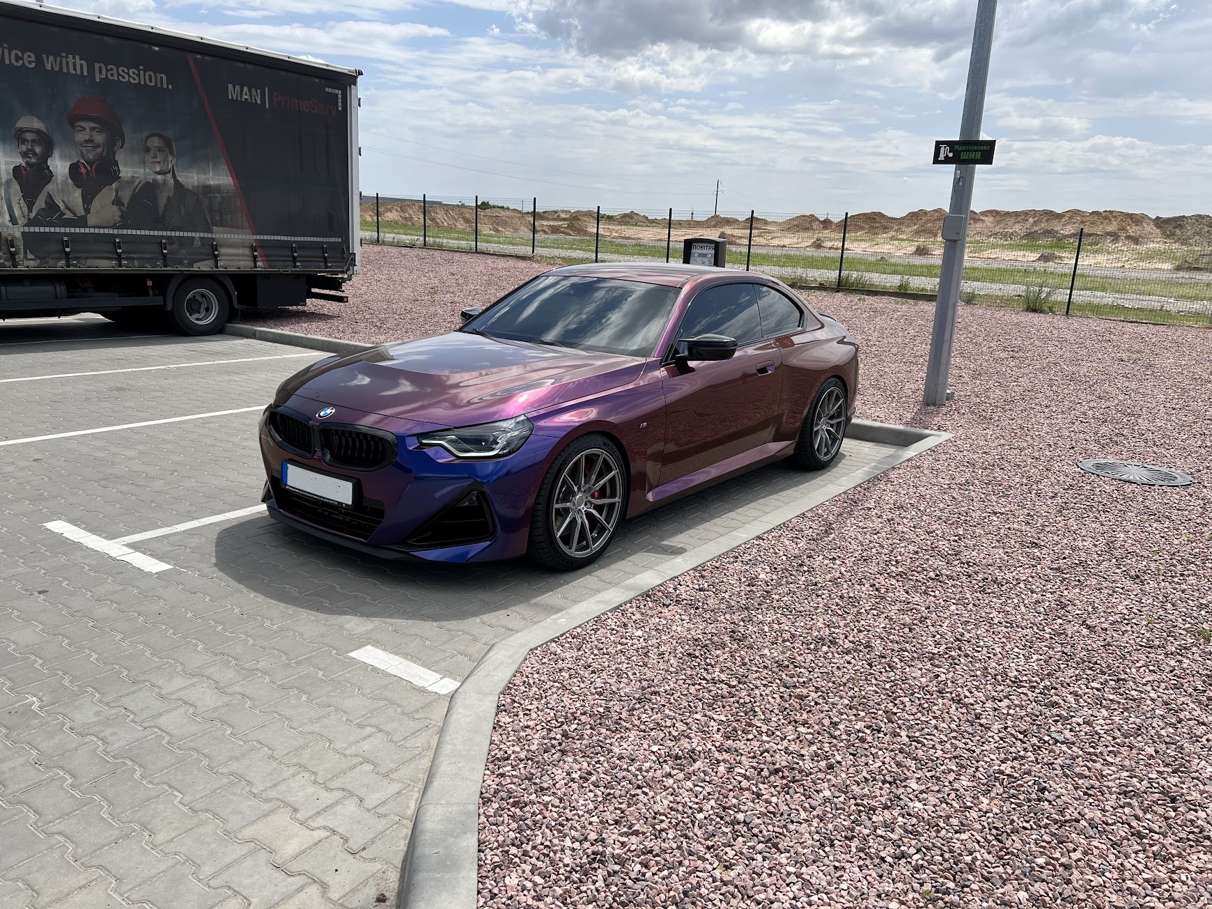 BMW G42 M240i rear three-quarter view showing aggressive widebody lines